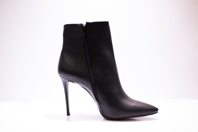 black leather boot on white surface